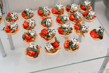 Catering. Off-site food. Buffet table with various canapes and snacks. - obrazy, fototapety, plakaty