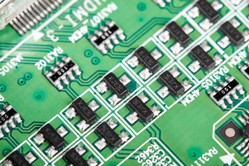 Close-up of a green computer printed circuit board with chips