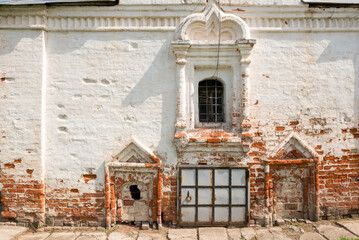 Church windows on old brick wall