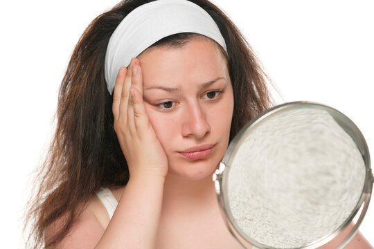 Headshot Of Unhappy Chubby Woman Doing Thinking Pose In The Mirror