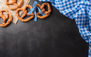 Oktoberfest festival decoration symbols made from Pretzel loaf and Bavarian white and blue fabric...