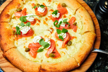 Pizza with salmon and cream cheese. Close-up, selective focus
