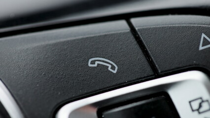 Bluetooth buttons located on the steering wheel of a car to talk over the phone hands free. Button...