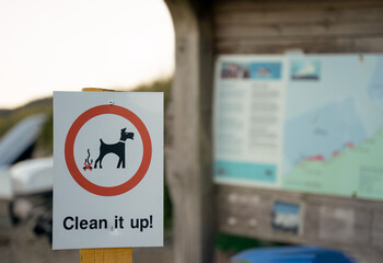 notice sign for dog owners to clean up dog poo excrement after fouling