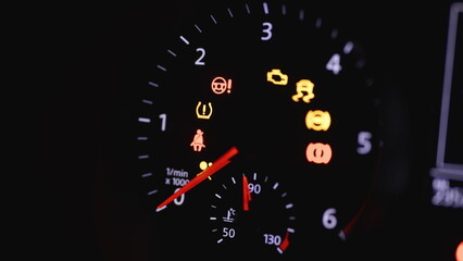 Fototapeta premium Tachometer Gauge of Starting and Stopping Car. Starting car engine. Dashboard in the car. Many different car dashboard lights with warning lamps illuminated