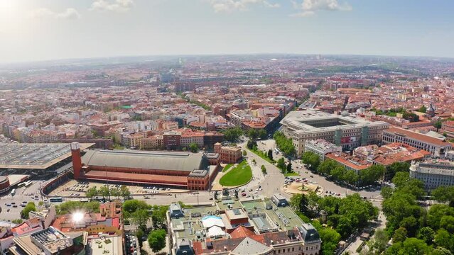 Amazing aerial view Atocha train station largest railway station in Madrid and all Spain station overlooks Plaza of Imperator Carlos V large buildings busy roads and big roundabout famous attraction
