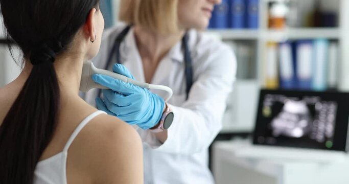 Doctor's hands with a probe on a woman's neck