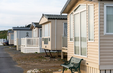row of static caravan trailers in a holiday park for rent - obrazy, fototapety, plakaty