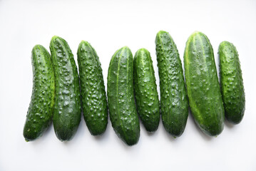 Green juicy cucumbers on a white background.