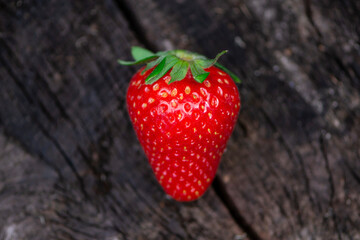 appetizing strawberries on an old dark wooden background close-up