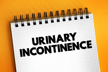 Urinary incontinence - leaking of urine that you can't control, text concept on notepad