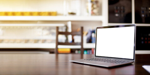 Mockup image of laptop with blank white desktop screen on a wooden table in an ordinary apartment. Laptop with blank screen for design. Banner with a laptop on the background of a home rack.