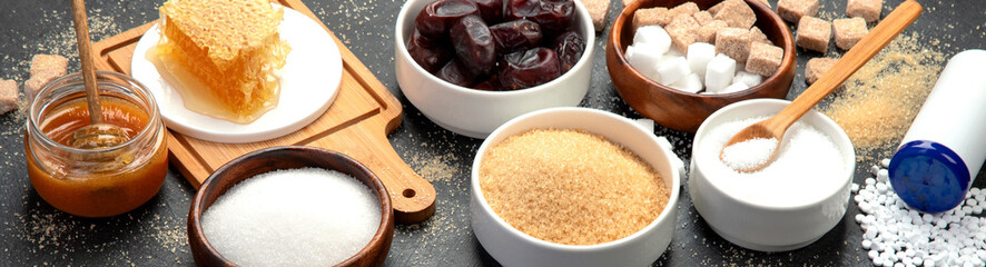 Various diet replacement for sugar on dark background.