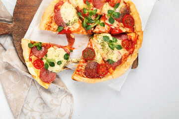 Pepperoni pizza on light background.