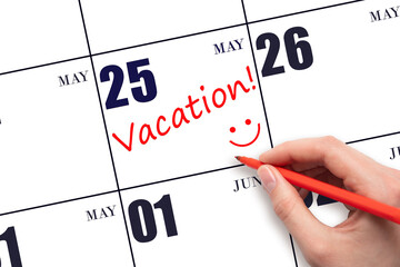 A hand writing a VACATION text and drawing a smiling face on a calendar date 25 May. Vacation...