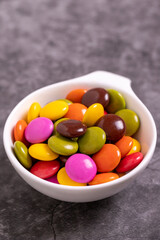 Colorful candies or bonbon. Chocolate filled candy on a dark background. close up