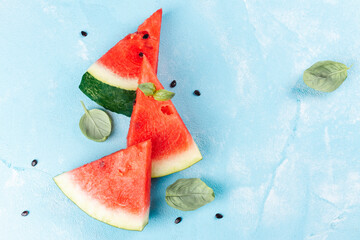 Slices of watermelon on blue