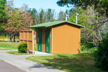 Fototapeta na wymiar Rural public restroom facility located at a roadside park