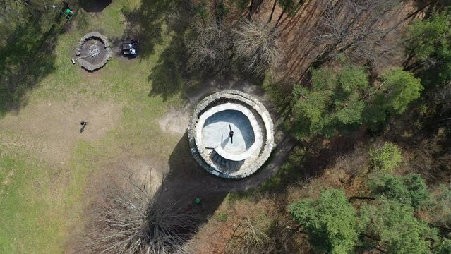 Top Down Aerial View, Lonely Girl Spinning With Split Hands on Top of Medieval Tower on Sunny Day, Ascending Drone Shot