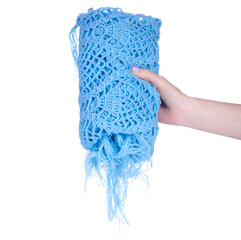 A blue scarf cape is crocheted handmade in hand on white background isolation