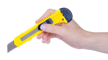 Yellow stationery knife in hand on white background isolation
