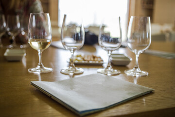 White wine testing and a menu  in a luxurious restaurant