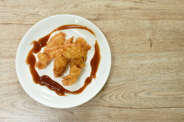 crispy fried chicken fillet with bread crumb and egg yolk on plate dipping ketchup