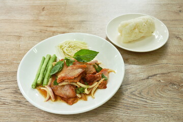 Thai spicy slice barbecue pork neck salad eat couple fresh cabbage and yard long bean on plate with sticky rice 