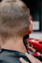 Haircut men Barbershop. Men's Hairdressers, barbers. Barber cuts the client machine for haircuts.
