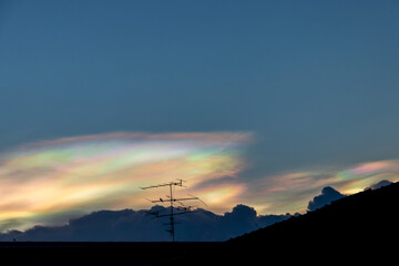 Beautiful iridescent cloud, Irisation. Skyscraper background.