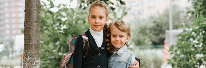 back to school. little happy kid pupil schoolgirl eight years old in fashion uniform with backpack...
