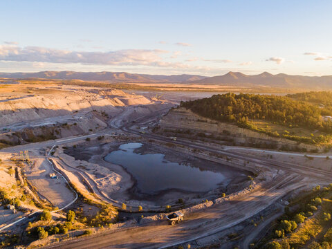 Aerial view of open cut coal mine with water near Singleton