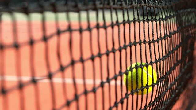 Super Slow Motion Shot of Tennis Ball Hitting the Net on Court at 1000fps.