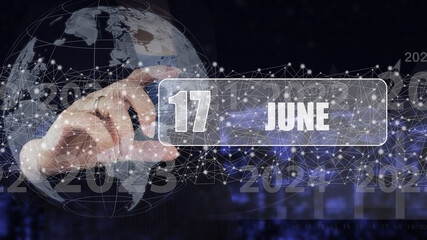 June 17th. Day 17 of month, Calendar date. Hand hold virtual screen card with calendar date.  Summer month, day of the year concept.