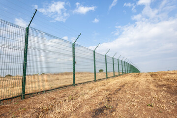 Fototapeta na wymiar New Security Steel Electrified Wire Fencing Boundary Outdoors.