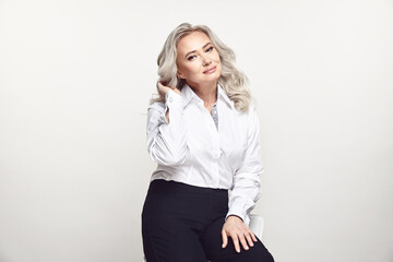 Older beautiful woman in stylish casual look on isolated background