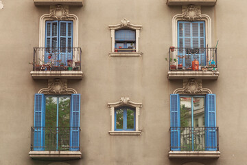 Six old window with blue wooden shutters. Reflection in glass. Barcelona, Catalonia Spain