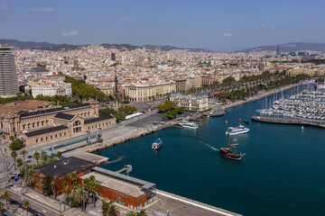 Naklejka na ściany i meble Barcelona, Catalonia Spain - 24.09.2021: Aerial view of the city from the overhead cable car, which crosses Port Vell, Barcelona's old harbour.