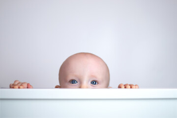 cute cute baby peeking out on white background.