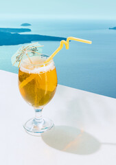 Glass of delicious lemonade isolated over sea landscape background. Refreshing drink
