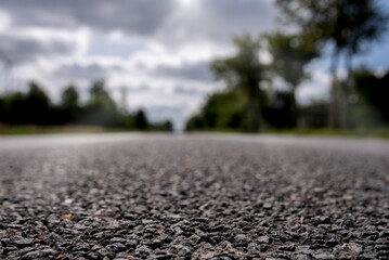 Closeup of empty asphalt road on a cloudy day