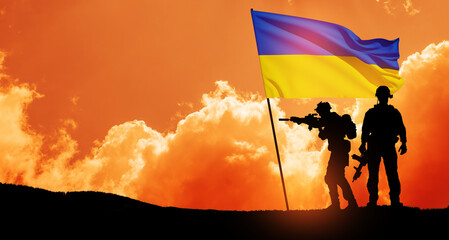 Flag of Ukraine with silhouette of soldiers against the sunrise or sunset. Concept - armed forces...