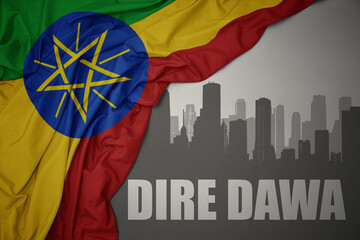 abstract silhouette of the city with text Dire Dawa near waving colorful national flag of ethiopia on a gray background. - obrazy, fototapety, plakaty