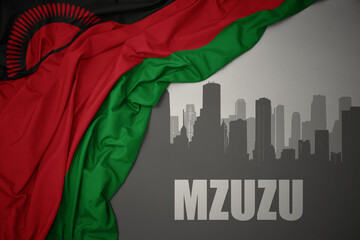 abstract silhouette of the city with text Mzuzu near waving colorful national flag of malawi on a gray background.