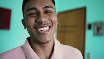 Obraz premium One happy hispanic man laughing and smiling at camera