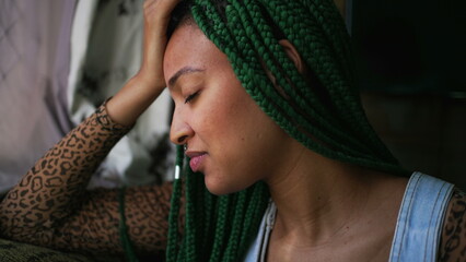 One anxious young woman suffering alone. A millennial black girl having mental distress