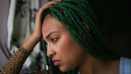 One anxious young woman suffering alone. A millennial black girl having mental distress