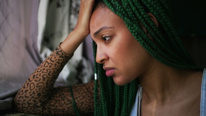 One anxious young woman suffering alone. A millennial black girl having mental distress
