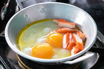 Eggs are cooked in a little pan served in, and topped with sweet sausage and pork stick. Pan Eggs or 