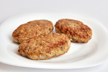 Fried meatballs on a white plate.